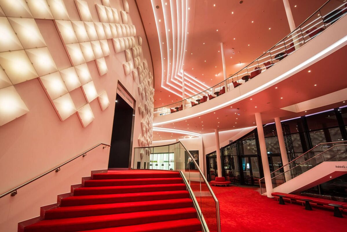 Stairs to the scene of the Stage Theater an der Elbe with OLED installation on the wall