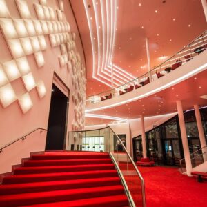 Stairs to the scene of the Stage Theater an der Elbe with OLED installation on the wall