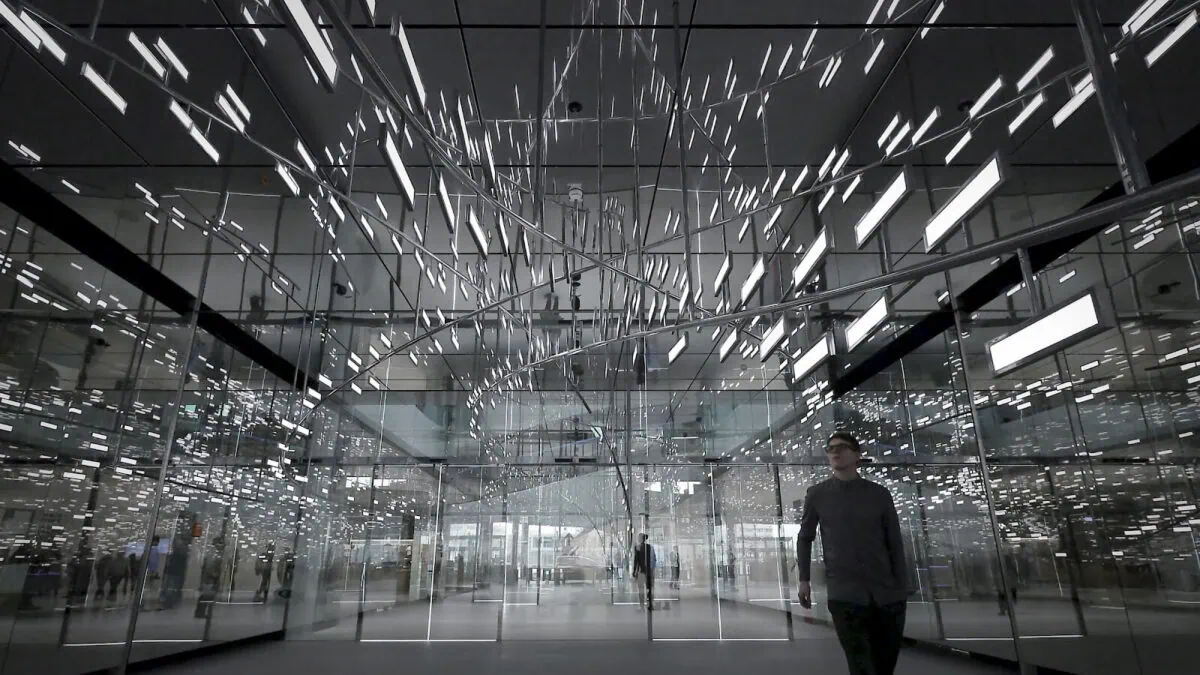 Man goes through the room with OLED lighting installation Light Cloud