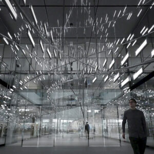 Man goes through the room with OLED lighting installation Light Cloud