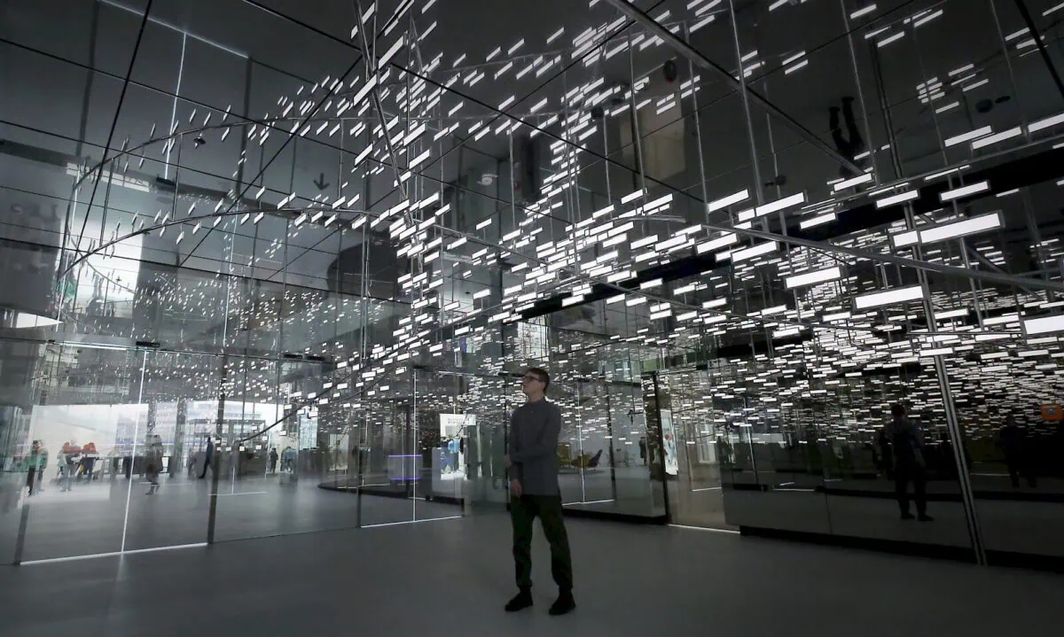 Man stands in the middle of OLED lighting installation Light Cloud