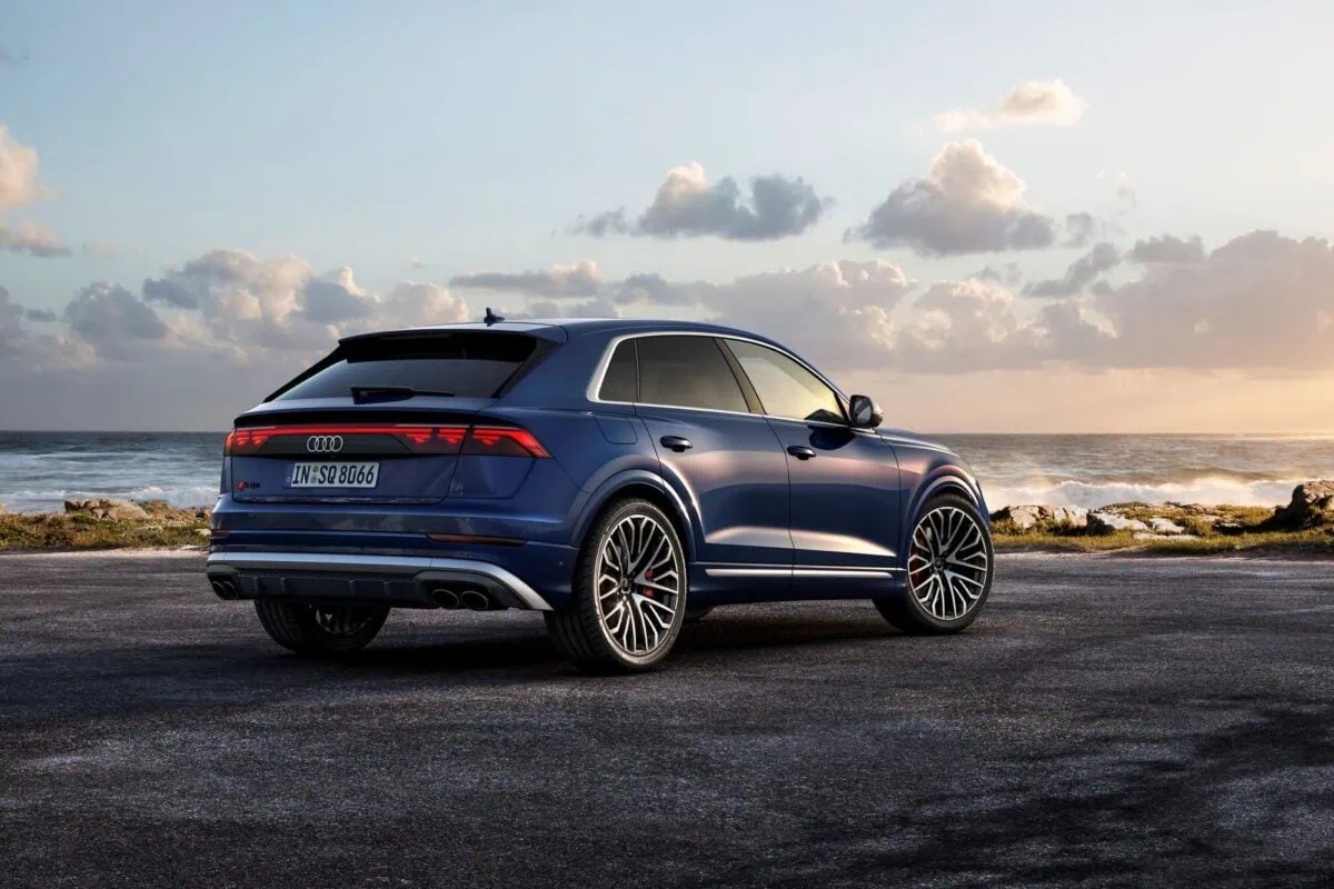 Audi Q8 with digital Atala OLED rear lighting. Parked car with sky and clouds in the background.